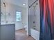 Clean bathroom with a shower-tub combination, white vanity, and wood-look floors at 544 Fox Chase Dr., Conway, SC 29527