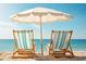 Relaxing beach scene with two beach chairs and a sun umbrella, perfect for enjoying a sunny day by the ocean at 544 Fox Chase Dr., Conway, SC 29527