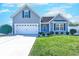 Charming home with blue siding, a well-manicured lawn, and an attached two-car garage at 544 Fox Chase Dr., Conway, SC 29527