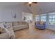 Bright living room with vaulted ceiling, wood floor, and large windows showing the lawn at 544 Fox Chase Dr., Conway, SC 29527