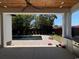 Covered back porch with ceiling fan overlooking a pool and manicured yard at 5515 Porcher Ave., Myrtle Beach, SC 29577