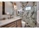 Bathroom featuring a marble shower, marble countertop, and decorative fixtures at 5515 Porcher Ave., Myrtle Beach, SC 29577