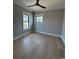 Cozy bedroom with natural light, hardwood floors, and a ceiling fan at 5515 Porcher Ave., Myrtle Beach, SC 29577