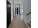 Entryway features a modern front door, contemporary lighting, and light hardwood flooring at 5515 Porcher Ave., Myrtle Beach, SC 29577