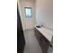Modern laundry area with sink, granite countertop, and gray tile floor at 5515 Porcher Ave., Myrtle Beach, SC 29577