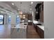 Open living room with a coffered ceiling flowing into a kitchen featuring a marble island at 5515 Porcher Ave., Myrtle Beach, SC 29577