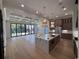 Open living room with coffered ceilings and hardwood floors looking into the kitchen and backyard pool at 5515 Porcher Ave., Myrtle Beach, SC 29577