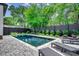 Backyard pool with brick surround and black lounge chairs at 5515 Porcher Ave., Myrtle Beach, SC 29577