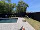 Backyard pool with landscaping, a black fence, and hardscaped patio at 5515 Porcher Ave., Myrtle Beach, SC 29577