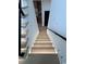 Staircase with wooden steps and stylish lighting leading to the kitchen at 5515 Porcher Ave., Myrtle Beach, SC 29577