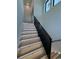 Modern staircase with wooden steps and black metal railing, enhanced with unique step lighting at 5515 Porcher Ave., Myrtle Beach, SC 29577