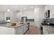 Bright kitchen with stainless appliances, granite counters, island, and white cabinetry at 585 Haven View Way, Murrells Inlet, SC 29576