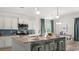 Well-lit kitchen featuring white cabinets, granite countertops, stainless steel appliances, and dining area at 585 Haven View Way, Murrells Inlet, SC 29576