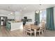 Open kitchen and dining area with stainless appliances, island, and breakfast bar at 585 Haven View Way, Murrells Inlet, SC 29576