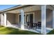 Covered patio with white pillars, table, and chairs, creating a comfortable outdoor dining area at 585 Haven View Way, Murrells Inlet, SC 29576