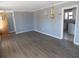 Open-concept living room with chandelier and hardwood floors at 633 Redwood Ave. # 1, Myrtle Beach, SC 29577