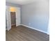 This is a bedroom with gray walls, wood flooring, and closet with louvered doors is open at 637 Redwood Ave. # 1, Myrtle Beach, SC 29577