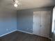 This is a bedroom with grey walls, wood flooring, and a closet with louvered doors at 637 Redwood Ave. # 1, Myrtle Beach, SC 29577