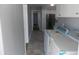 Hallway view showcasing a laundry room, and connecting to a kitchen with stainless steel appliances at 637 Redwood Ave. # 1, Myrtle Beach, SC 29577