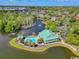 Aerial view of the community pool and clubhouse surrounded by lake at 707 Compass Pointe Dr, North Myrtle Beach, SC 29582
