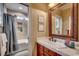 Bathroom with soaking tub/shower combination, large framed mirror above vanity, and tiled flooring at 707 Compass Pointe Dr, North Myrtle Beach, SC 29582