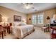 Well-lit bedroom showcases a large window, ceiling fan, neutral carpet, and bedside furniture and decor at 707 Compass Pointe Dr, North Myrtle Beach, SC 29582