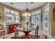 Charming dining room with large windows, chandelier, and a glass-top dining table at 707 Compass Pointe Dr, North Myrtle Beach, SC 29582