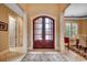 Grand foyer with arched front door with sidelights, tile floor and columns at 707 Compass Pointe Dr, North Myrtle Beach, SC 29582