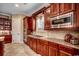 Gourmet kitchen featuring stainless steel appliances, tile backsplash, and wooden cabinets at 707 Compass Pointe Dr, North Myrtle Beach, SC 29582