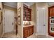 Butler's pantry with a glass cabinet and granite countertops at 707 Compass Pointe Dr, North Myrtle Beach, SC 29582
