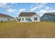 Home's backyard with green grass, patio and beautiful exterior view at 816 Wailea Circle, Little River, SC 29566