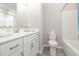 Elegant bathroom featuring a large mirror, white cabinets and modern fixtures at 816 Wailea Circle, Little River, SC 29566