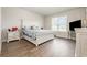 Spacious bedroom features hardwood floors, a large window, and a comfortable queen size bed at 816 Wailea Circle, Little River, SC 29566