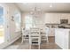 Bright breakfast nook features white cabinets, dining table and natural light at 816 Wailea Circle, Little River, SC 29566