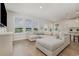 Spacious living room showcasing a sectional sofa, large windows, and wood-look flooring at 816 Wailea Circle, Little River, SC 29566