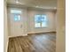 Bright living room with luxury vinyl plank flooring, white trim, and a large window at 9021 Aria Way, Longs, SC 29568