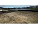 Dirt lot backyard overlooking a pond and other homes in the community at 903 Agostino Dr., Myrtle Beach, SC 29579