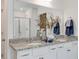 Bright bathroom featuring double sinks with granite countertops, white cabinets, and modern fixtures at 903 Agostino Dr., Myrtle Beach, SC 29579