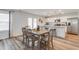 Bright dining area featuring hardwood floors, a stylish table set, and modern white kitchen in the background at 903 Agostino Dr., Myrtle Beach, SC 29579