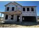 New home construction featuring the exterior frame, windows, and doors awaiting finishes and siding at 903 Agostino Dr., Myrtle Beach, SC 29579