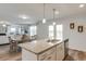 Granite kitchen island offering bar seating with stainless steel appliances, dining area, and living area in the background at 903 Agostino Dr., Myrtle Beach, SC 29579