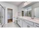 Bright bathroom featuring a double vanity, tiled floors, and a glass enclosed shower with a view of the walk-in closet at 915 Agostino Dr., Myrtle Beach, SC 29579