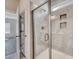 Close up of a shower with glass door, chrome fixtures, and tiled walls; room with wood floors in the background at 915 Agostino Dr., Myrtle Beach, SC 29579