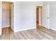 Inviting bedroom showcasing wood-look floors and access to a walk-in closet and en-suite bathroom at 915 Agostino Dr., Myrtle Beach, SC 29579