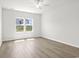 Light-filled bedroom showcasing wood-look flooring and a large window with view of the neighborhood at 915 Agostino Dr., Myrtle Beach, SC 29579