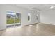 Bright living room boasts wood-look flooring, a ceiling fan, and sliding glass doors to the backyard at 915 Agostino Dr., Myrtle Beach, SC 29579