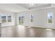 Bright, airy living room with wood-look flooring, ceiling fan, and large windows letting in ample natural light at 915 Agostino Dr., Myrtle Beach, SC 29579