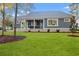 Backyard view of a home with a screened-in porch and lush green grass at 1001 Brantley L Brantley Ln., North Myrtle Beach, SC 29582