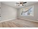 Bright bedroom with natural light from the window featuring a ceiling fan and wood-look floors at 1001 Brantley L Brantley Ln., North Myrtle Beach, SC 29582