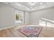 Spacious bedroom featuring wood floors, large windows, and an elegant chandelier at 1001 Brantley L Brantley Ln., North Myrtle Beach, SC 29582